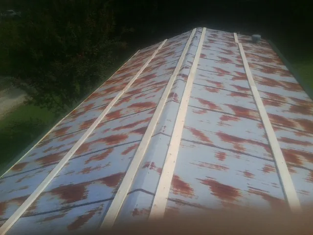 Rusted metal roof panels with new wood purlins before replacement — Storm Damage Roof Repair in Weirton by Roofing Brothers